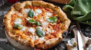 Italian Pizza Napoletana in Messy Kitchen with Cooking Ingredients such as tomato, olive oil, garlic, basil, rolling pin, flour, knife, cutting board Stock Photo – Alamy