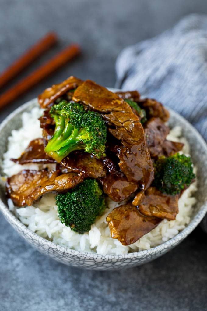 A bowl of beef and broccoli stir fry served over rice. | Broccoli beef, Easy beef and broccoli, Beef with broccoli recipe