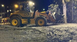 Crews search for possible missing after a mudslide in the Italian Alps coats city streets in muck