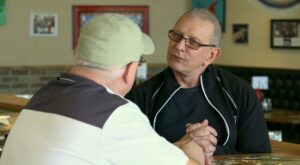 Chef Robert Irvine, speaking with local Chef Robert Brunet from Momma Pearl’s Cajun Kitchen, for Restaurant: Impossible in late 2021. Image courtesy Food Network.